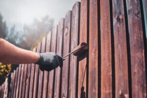 process-fence-renovation-bright-sunny-day-by-man-protective-gloves