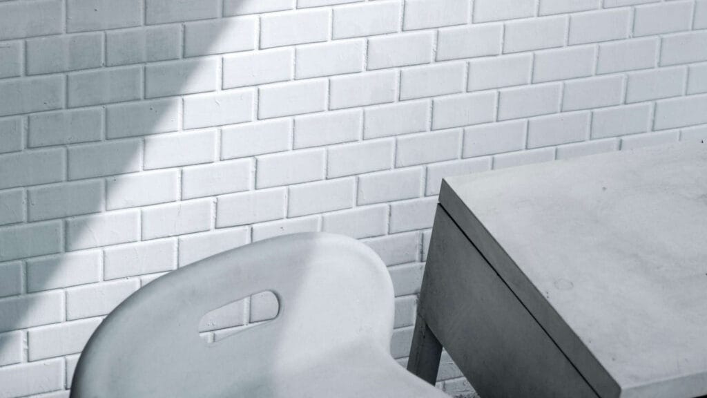 whitewash brick wall with table and chair