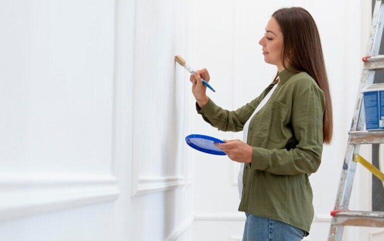 woman painting wall home