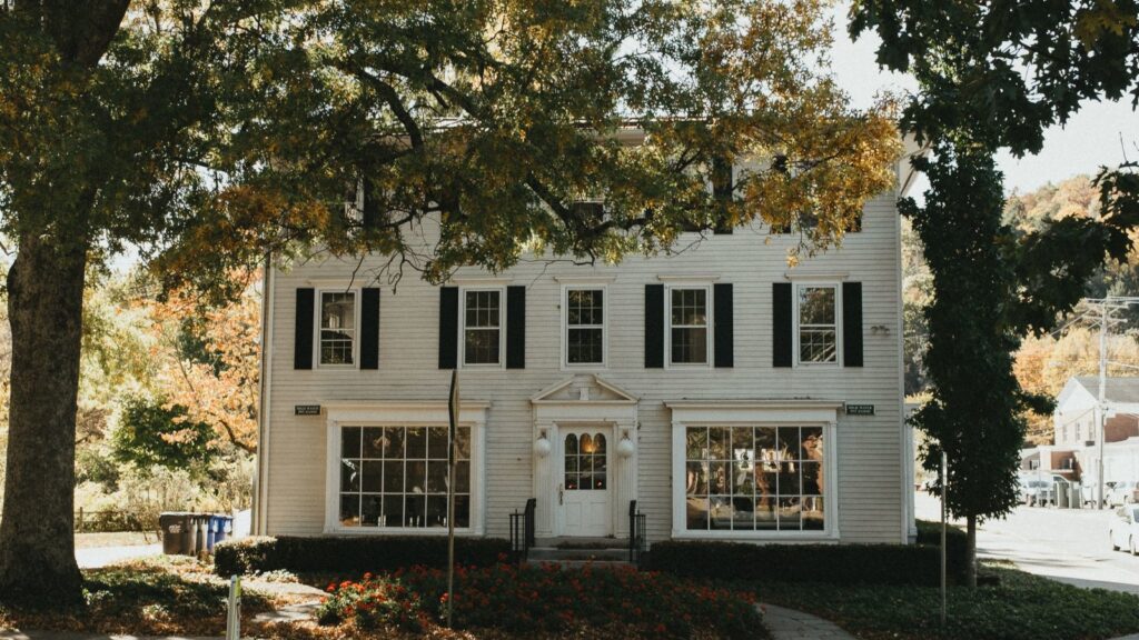 Charming Colonial-style house in Connecticut surrounded by autumn foliage, illustrating exterior home appeal.