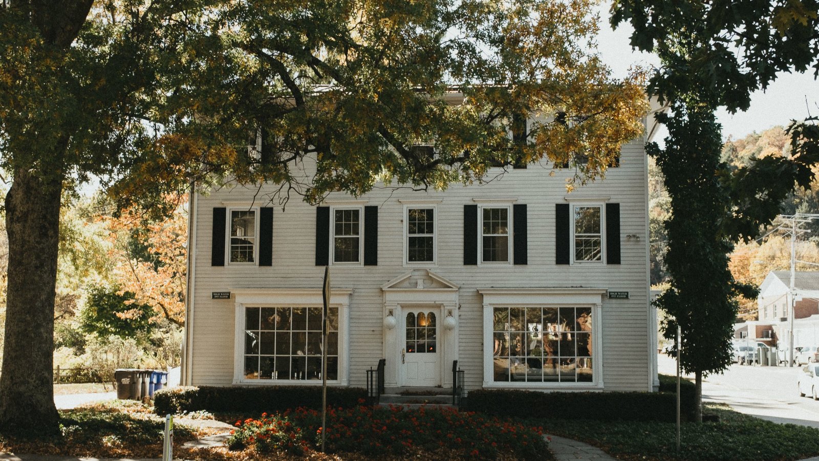 Charming Colonial-style house in Connecticut surrounded by autumn foliage, illustrating exterior home appeal.
