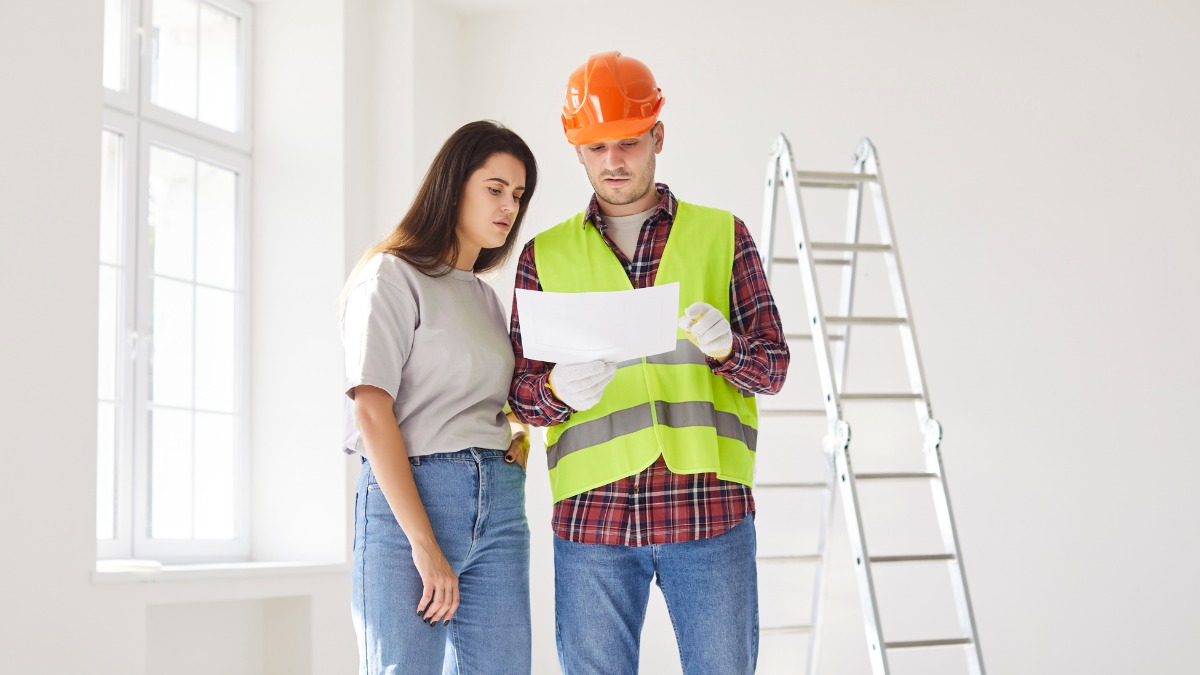 contractor reviewing document with homeowner