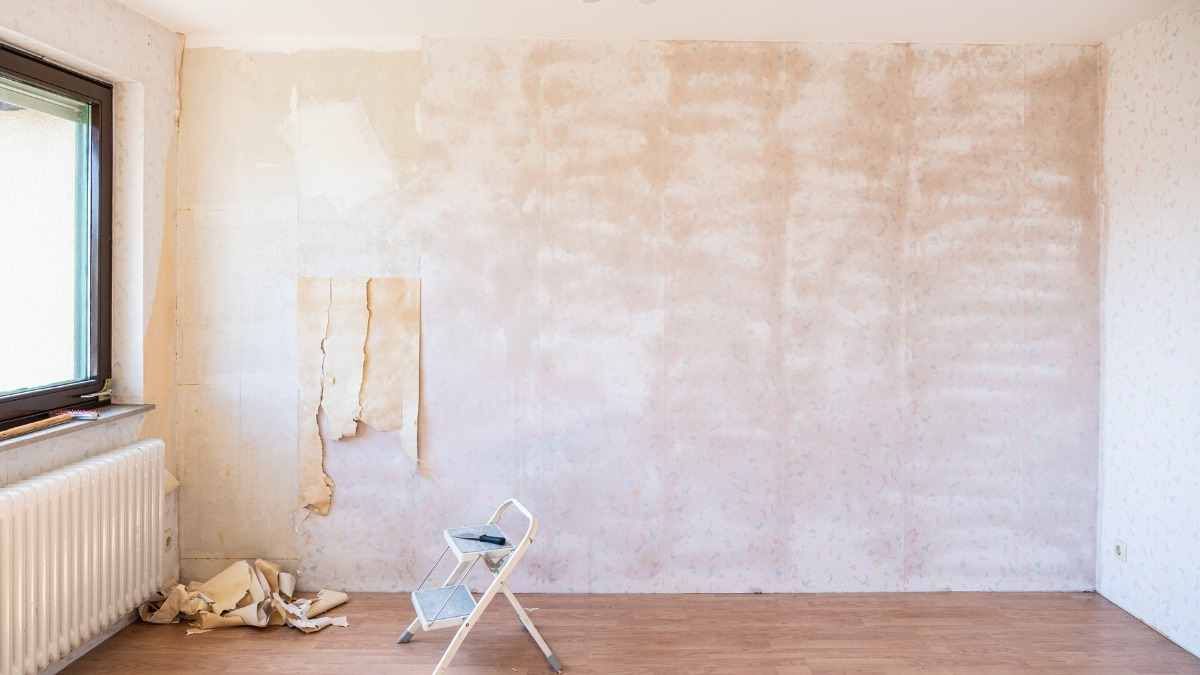 old wallpaper partially removed from the wall